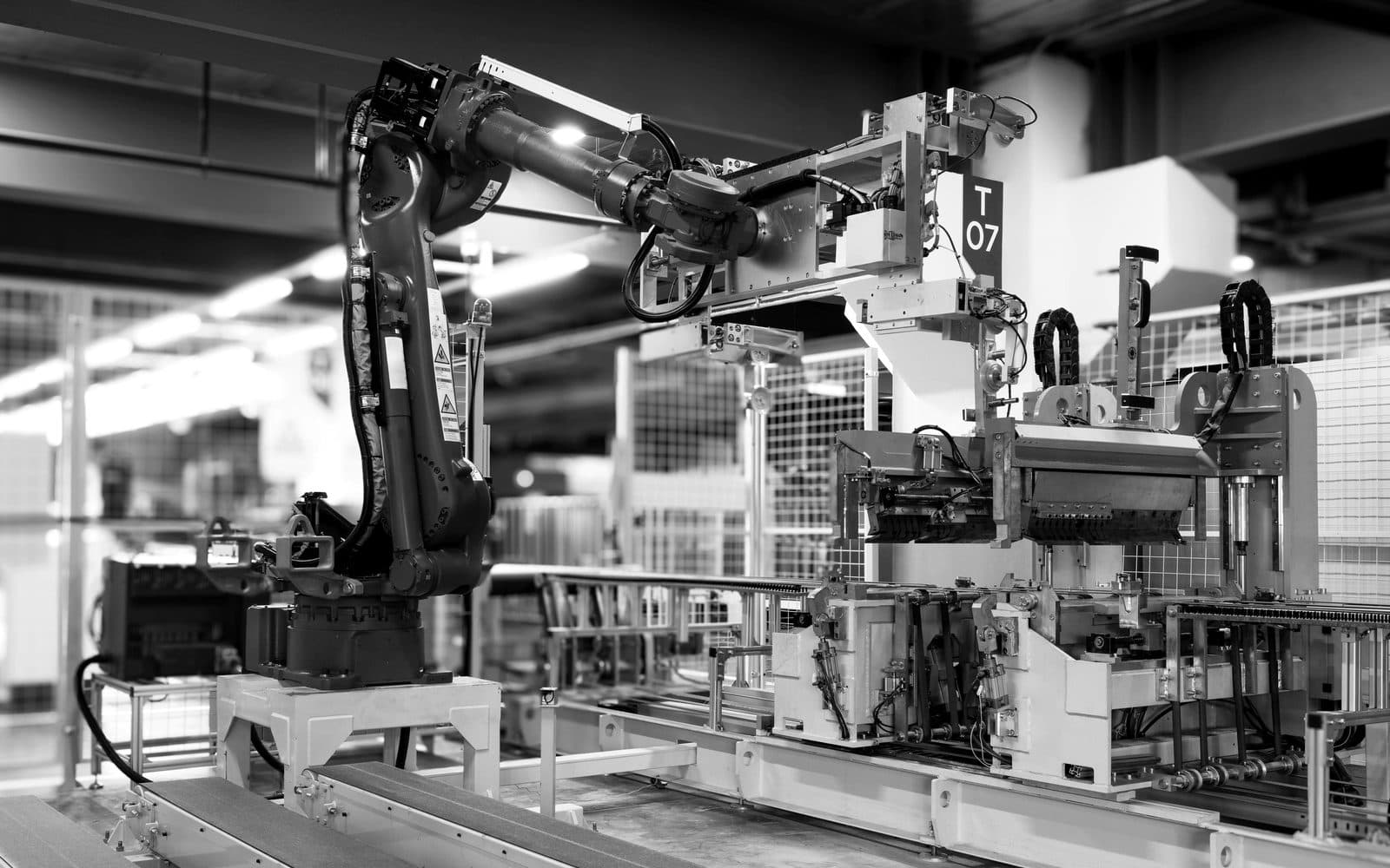 Close-up of a production line inside a modern Asian factory with workers inspecting manufactured products