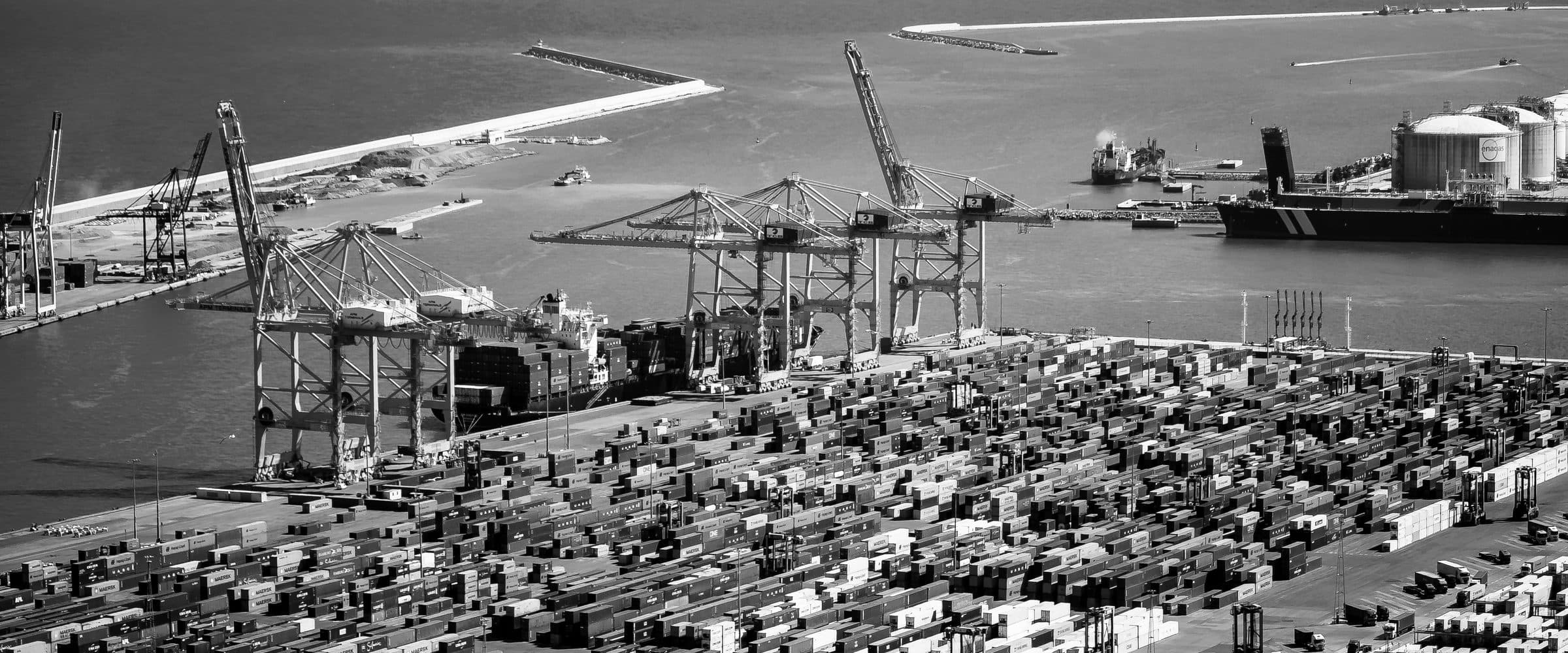 Aerial view of a major logistics hub showing factory, warehouse and port infrastructure together